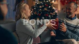 Find thoughtful christmas gift ideas for husband such as amish crafted brown alligator skin bifold wallet, i'm hooked on you personalized fishing lure, bose quietcomfort headphones. Christmas Family Opening Presents Husban Stock Video Pond5