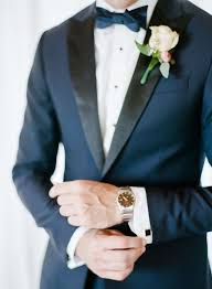 Black And White Suit With Bow Tie Navy Blue And Black Grooms Suit With A White Rose Boutonniere And Bow Tie For A Perfect Groom Groom And Groomsmen Style Navy Tuxedos Groom And Groomsmen Attire