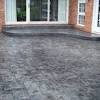 It is concrete with a brick border. 1