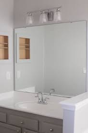 Redo your bathroom mirror with this diy bathroom mirror project. How To Frame A Bathroom Mirror Easy Diy Project