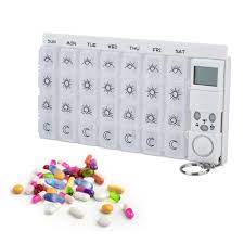 This pill organizer has seven slots for each day of the week, and each slot holds a pill box with four compartments to divide up your pills. Pill Case Capsule Organizer Alarm Reminder 28 Grids Tablets Storage Bo Owlet