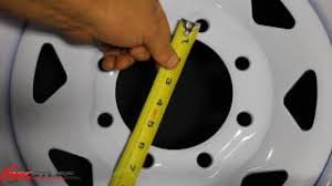 You measure from the backof one lug (skip to next lug as shown) and to the center of that lug. Measuring Your Wheel S Bolt Pattern Recstuff Com