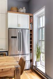 Two Tone Cabinets And An Open Wood Island In A Sunny Kitchen Chic and functional in black and white.