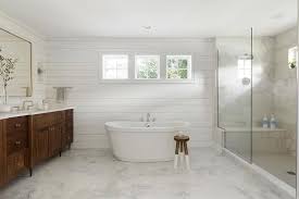 Simple White Bathroom Design With Marble Floor Tiles Wood Cabinets And White Shiplap Walls Refin White Marble Floor Shiplap Bathroom White Bathroom Designs