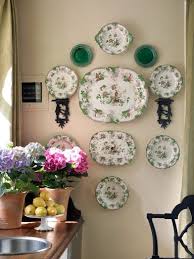 Look at each plate a disorganised arrangement creates an undulating mass of plates that wander off to a side or up a. Decorating With Wall Sconce Shelves Plate Wall Decor Plates On Wall Plate Decor