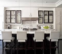 Two tone kitchen features white upper cabinets and blue lower cabinets paired with white and grey quartzite countertops and a white subway tiled backsplash accented with dark grout. Love The Barstools Transitional Kitchen Design Modern Kitchen Design Classic White Kitchen