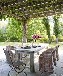 On The Terrace A Pergola Covered In White Wisteria Shades An Outdoor Dining Area With A Reclaimed Teak Table A Fre Small Patio Decor Patio Decor Patio Design