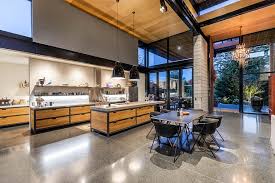 Stormy gray shake siding and stone masonry gives craftsman house plan 55603 a weathered, welcoming appearance. Double Height Living Spaces Add Drama To This Industrial Style House Industrial House Exterior House Living Spaces
