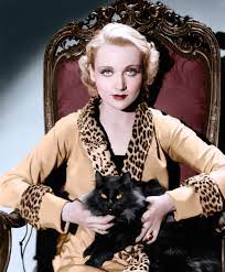 Carole Lombard Wearing A Jacket With A Leopard Skin Collar And Cuffs Holding A Black Cat On Her Lap In The 1930s C Old Hollywood Classic Actresses Hollywood