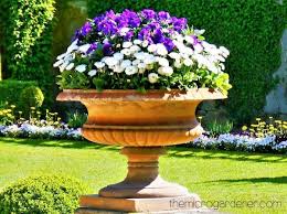 Red geraniums and pink petunias are among the flowers that make up this colorful garden. Ten Tips For Creating Beautiful Gardens The Micro Gardener