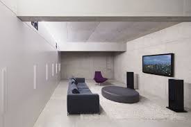 A Modern Living Room With Wall Mounted Tv Stereo Speakers And A Couch Home Theater Setup Home Theater Seating Home Theater Installation