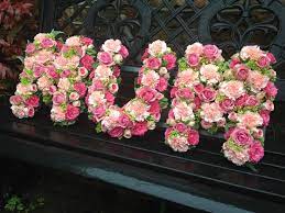 The bright sunflower bouquet is arranged by a florist near you with sunflowers, pink roses, green mums, orange carnations and more. Pink Rose Mum Floral Funeral Tribute Funeral Floral Arrangements Rose Flower Arrangements Funeral Flowers