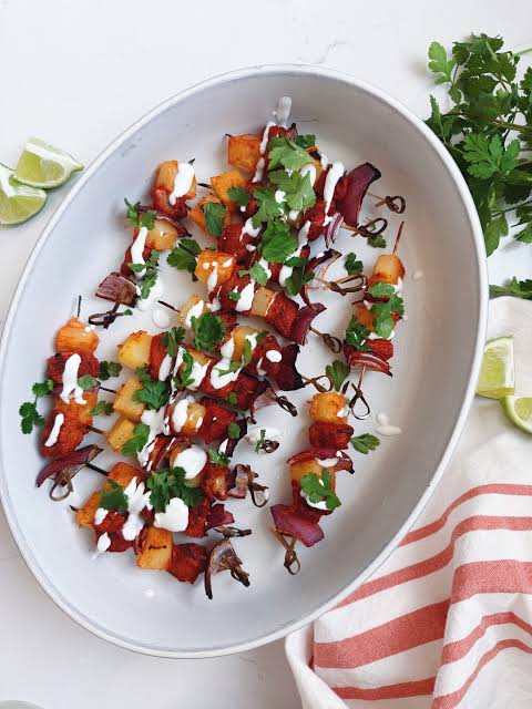 Completed plate of tacos al pastor with grilled pineapple, onion and cilantro
