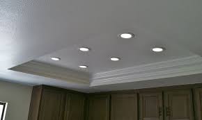 You can resurface the soffit with drywall and install recessed lights inside it. Replaced Ugly Fluorescent Panels In Kitchen With Recessed Leds Diy
