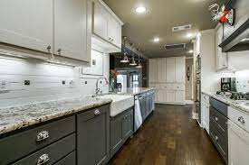 This galley styled kitchen has dark brown cabinetry and stainless steel appliances and fixtures. 25 Stylish Galley Kitchen Designs Designing Idea