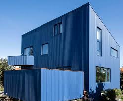 Dark blue paint with wood garage door and white trim. 31 Houses With A Blue Exterior Photos All Types Of Blue Home Stratosphere