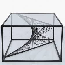The lower shelf features a delicate floral design, and is suspended from the table top. Black Metal Glass Coffee Table Black Metal Glass Coffee Table