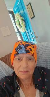Meet Warrior Carrie from Minnesota. She sent us these pictures. She likes  happy and fun fabrics. Here's what she wrote: Hi lovely folks! I received  some amazing beanies and courage caps from