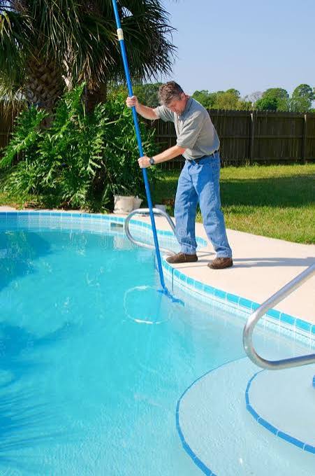 Clean, clear swimming pool water in a residential backyard