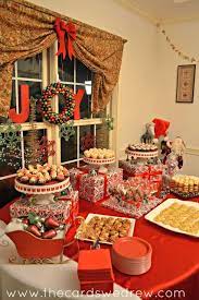Lay a trail of garland (real or artificial) across your dining or buffet table for a simple and elegant centerpiece that stretches the length of the table. Red And Green Christmas Party Christmas Buffet Christmas Party Food Christmas Party
