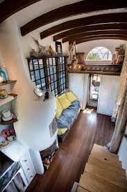 This tiny house airstream has an exterior and interior shower, lots of reclaimed pallet decor, green cork flooring and a futon. Bohemian Tiny House Constructed Using Reclaimed And Handmade Materials Idesignarch Interior Design Architecture Interior Decorating Emagazine