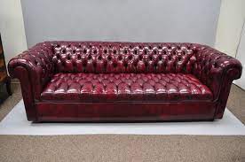 The polished stainless steel frame has angled legs. Large Oxblood Burgundy Red Leather Button Tufted Chesterfield Sofa For Sale At 1stdibs