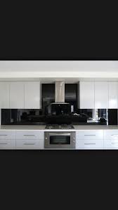 Ice White Cabinets With Polished Black Glass Splashback And Stainless Steel Appliances Love T Black Splashback Kitchen Splashback Designs Modern Black Kitchen