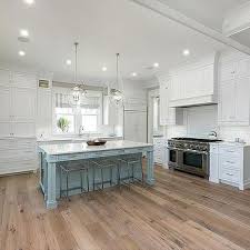 White Cabinets With Powder Blue Kitchen Island And Sawn Oak Wood Floors Beach House Kitchens Wood Floor Kitchen Grey Kitchen Island