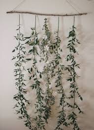 Easy Christmas Decoration Of Greenery Branches On A Long Stick For Wall Hanging Diy Backdrop Floral Backdrop Home Decor