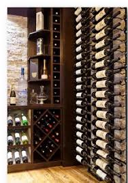 The wine room is a welcoming and fresh atmosphere that offers wine tasting, wine by the glass, wine bottle purchases, and a few beer options for those who are not wine lovers. A Small Basement Custom Wine Cellar With Elegant Wine Room Design