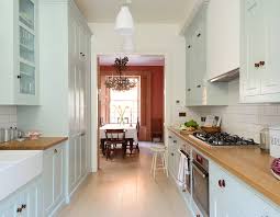 Ordinarily bright subway tiles reflect light to illuminate the smaller kitchens. Devol Classic Pimlico Kitchen Backsplash Is White Subway Tile Counters Are Wood Cabinets A Pale Blue Laurel Home