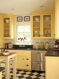 Pictures, ideas & tips from hgtv | hgtv. Updated Vintage Kitchen Yellow Paint A Checkerboard Floor And Soapstone Countertop Budget Kitchen Remodel Yellow Kitchen Cabinets Kitchen Remodeling Projects