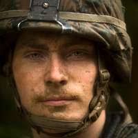Lance Cpl. Christopher Clark fixes a Humvee, May 28,
