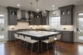 This transitional kitchen remodel pairs together oak and painted blue cabinets with a white subway tile backsplash and wide plank hardwood floors. Photos Of A Remodeled Kitchen In Alexandria Va