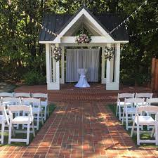Wedding Ceremony At The Ramada Greenery Roses Sprays White Drapery Tivoli Lights Downtown Atlanta Wedding Venues Atlanta Wedding Venues Space Wedding