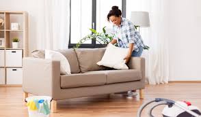 teal and sage green decorative pillows on white sofa
