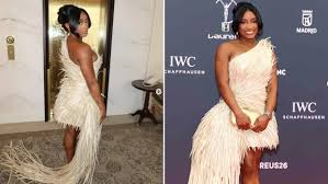 Simone Biles’ feathered red carpet dress came with a last-minute fix, and fans are praising the final result