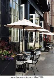 Stock Photo Outdoor Cafe Tables With Umbrellas Up And Places Set Waiting For Customers To Arrive Mesa Con Sombrilla Restaurantes Fachadas