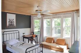 Three Words Cozy Cabin Vibes We Re Loving How The Natural Light Wood Paneling And Dark Green Com Bedroom Paint Color Inspiration Toddler Room Rooms Reveal