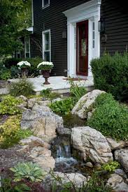 On the other side of the door, the water feature continues along the sidewalk with a gentle waterfall. Front Yard Water Features Boost Your Curb Appeal Aquascape Inc