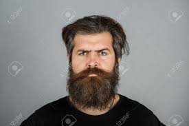 Portrait Of Confident Serious Man Has Beard And Mustache, Looks Seriously,  Isolated. Hipster Guy With Long Beard And Moustache. Bearded Man. Handsome  Male Model, Closeup Face. Stock Photo, Picture and Royalty Free