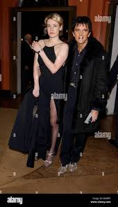 Emily Lloyd and Steve Strange arriving at the Cambridge Theatre in London  for the opening night of 'Our House' the musical, a comedy woven around the  greatest hits of Madness Stock Photo -