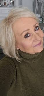 What is a good haircut for a 60-year-old with a round face and side bangs  in Murfreesboro, TN?