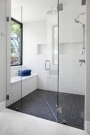 Laying the tile in a horizontal straight stack adds a modern feel to this stunning bathroom! White Shower Wall Tiles With Black Grid Shower Floor Tiles Transitional Bathroom