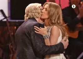 Celine Dion stands on stage and says to the audience, "well this afternoon,  I found out about two people who were coming tonight...". She continues,  "one is Olivia Harrison and the other