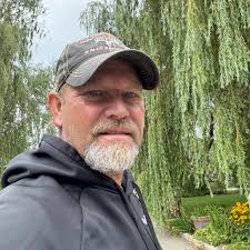 Who can build an external retaining wall using cedar trees around a fire  pit?