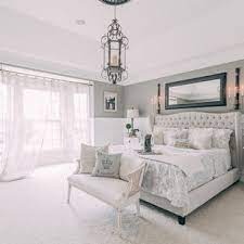 A focused shot at this primary bedroom's cozy bed surrounded by white walls and dark hardwood floors. 75 Beautiful Shabby Chic Style Bedroom Pictures Ideas July 2021 Houzz