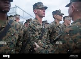 Sgt. Maj. Jerry Bates II presents his son, Rct. Jerry Bates III, with his  Eagle, Globe and Anchor emblem during a ceremony Dec. 14, 2013,