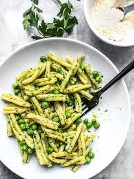 A Bowl Full Of Parsley Pesto Pasta With Peas With A Black Fork And A Bowl Of Parmesan On The Side Pasta With Peas Quick Pasta Recipes Pesto Pasta