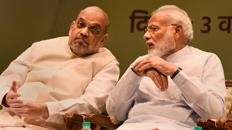 Portraits of Modi and Amit Shah on OPS camp hoarding raise eyebrows